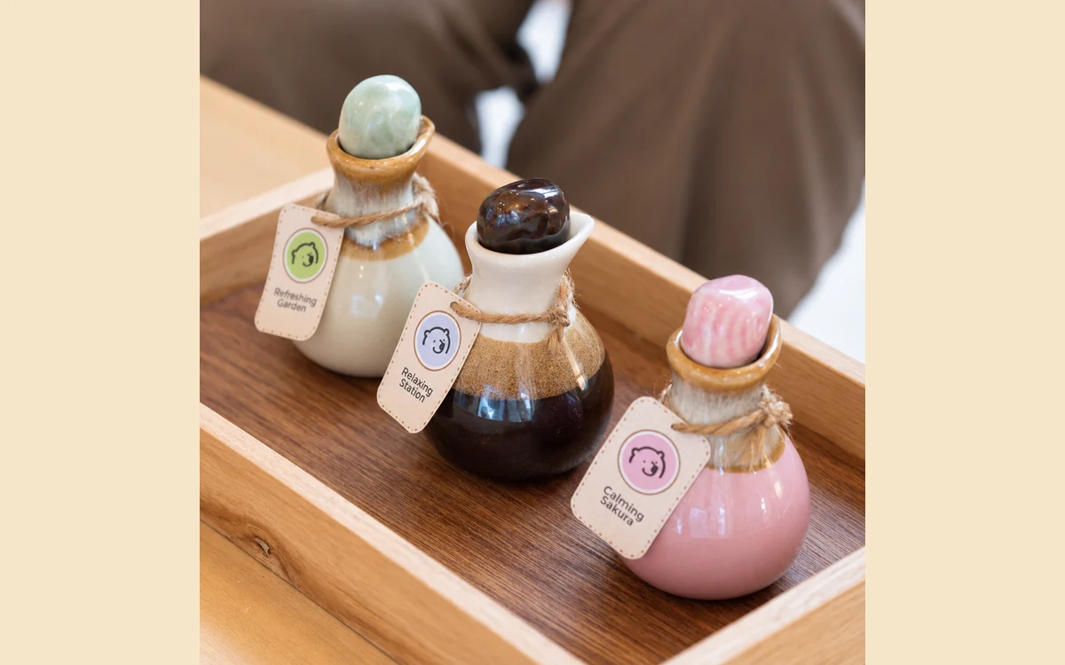 Colourful oil bottles arranged on a wooden tray