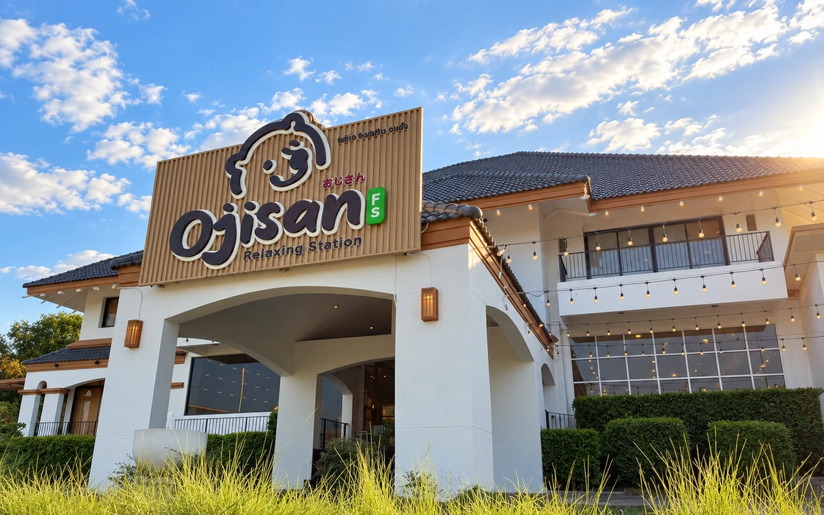 An Ojisan building exterior and shop sign beneath a bright sky